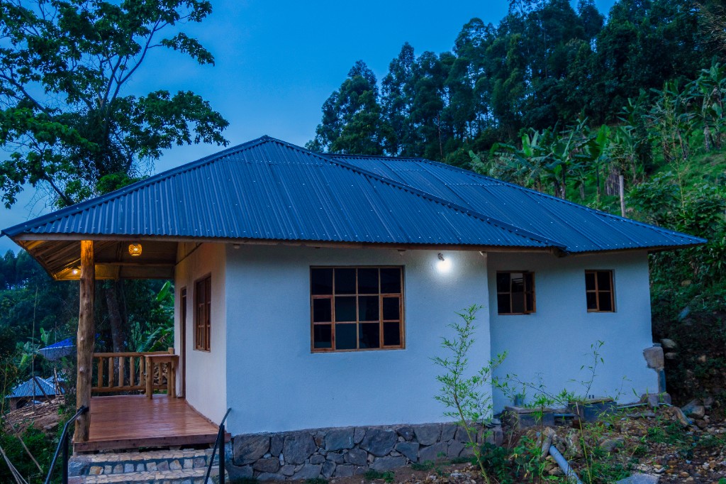 White cottage with blue roof at dusk