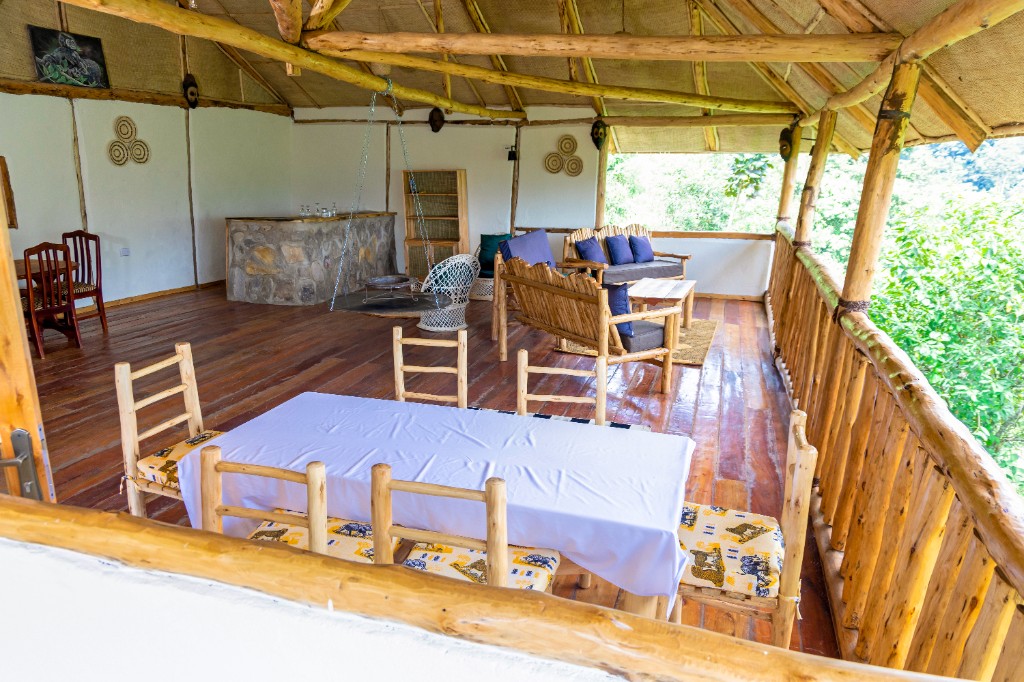 Open-air lodge lounge and dining area with forest views