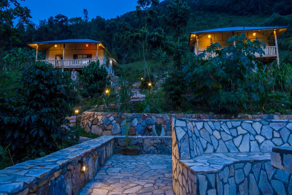 Stone paths between hillside cabins at evening
