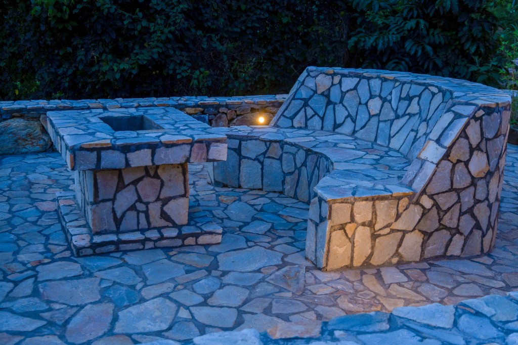 Stone patio with curved bench seating